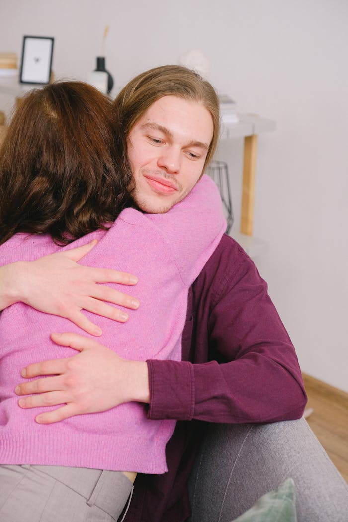 A joyful couple embracing indoors, expressing love and happiness, symbolizing a strong and tender relationship.